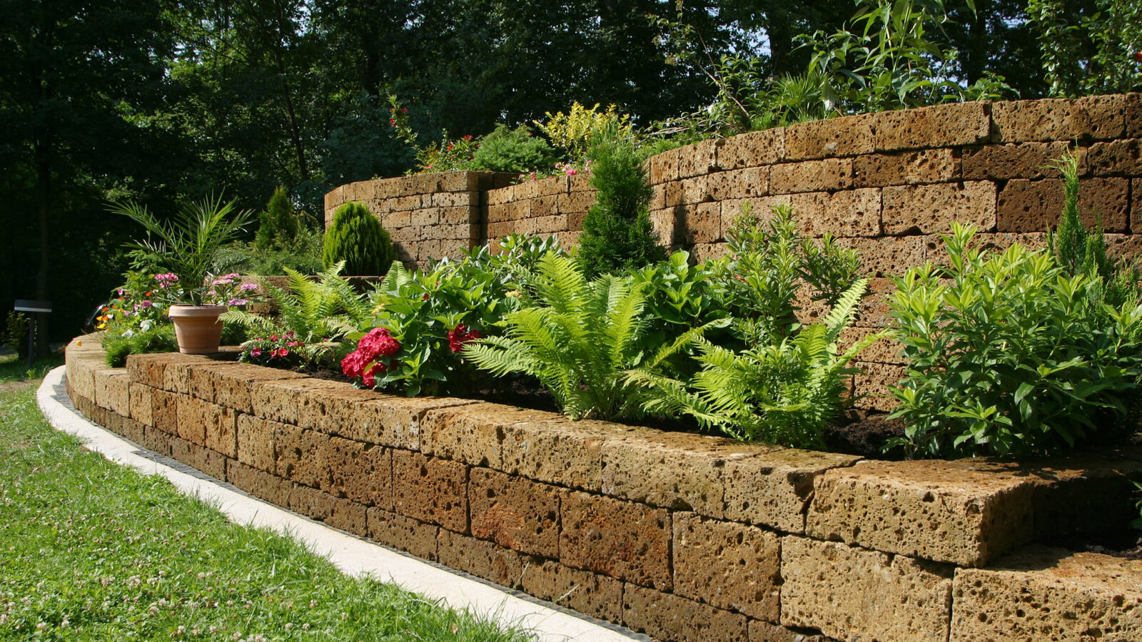 Block retaining wall terracing a sloped yard near Asheville, NC