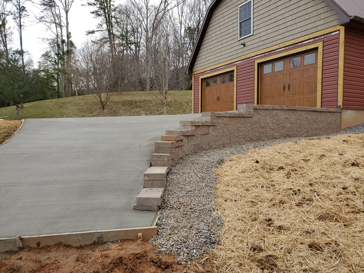 Crew finishing a freshly poured concrete slab on a Western North Carolina job site